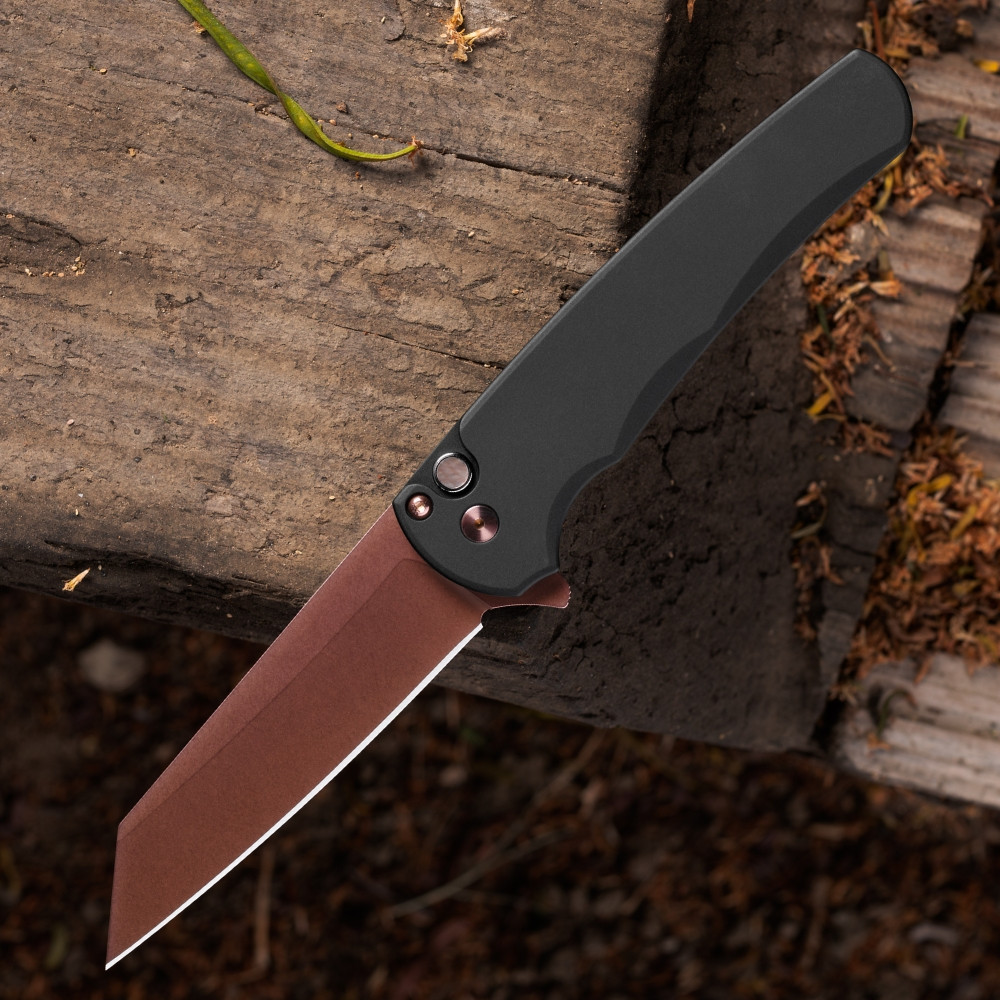 Pro-Tech Malibu BSA26.Malibu.1 shown open on a dark wood background. The copper rose PVD CPM MagnaCut reverse tanto blade is fully deployed, displaying the warm rose-toned PVD finish across the blade face. The black aluminum handle and black lip pearl button are visible at the base of the frame.