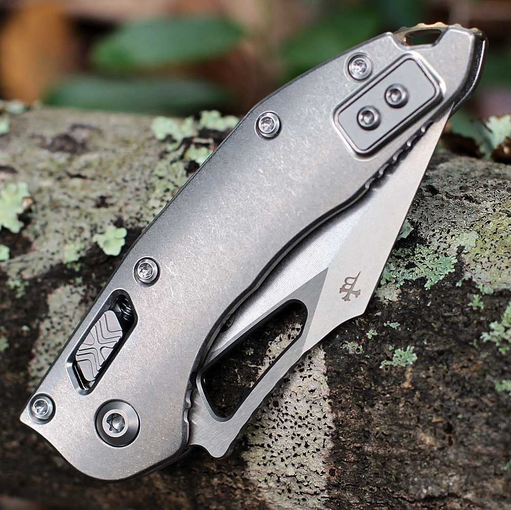 Microtech Mini Stitch RAM-LOK 169MRL-10MS1 stonewash titanium handle — RAM-LOK mechanism, bronze titanium accents, Microtech cross logo, partially open blade