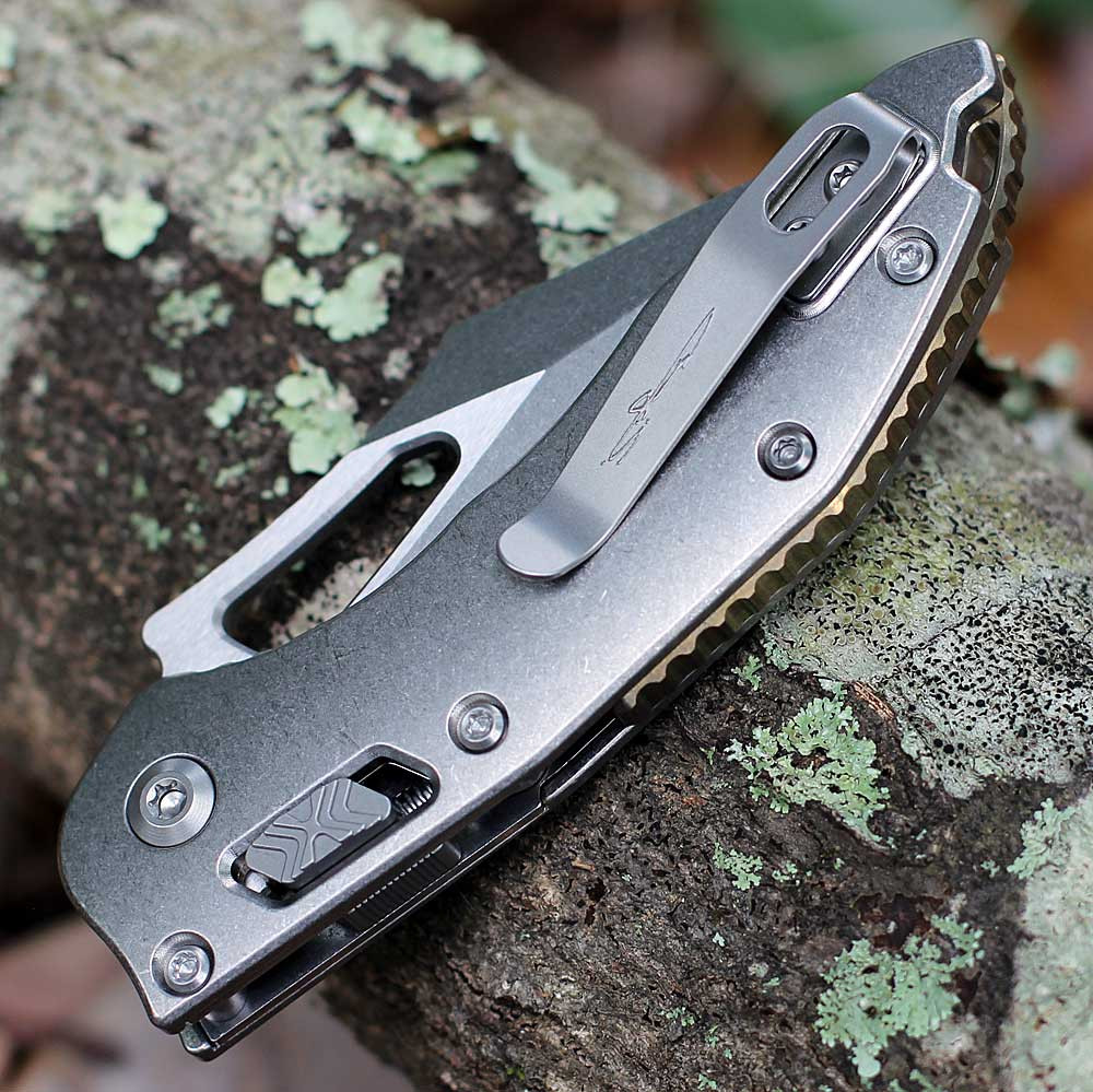 Microtech Mini Stitch RAM-LOK 169MRL-10MS1 spine view closed — stonewash slab side titanium handle, deep-carry titanium clip, bronze accent hardware
