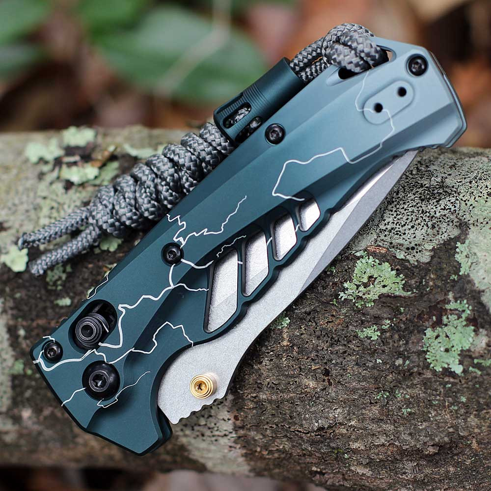 Benchmade Mini Adira 18065-ABEL1 spine view closed — Abel Dark Waters Lightning teal aluminum handle, ported scales, paracord lanyard, gold thumb stud