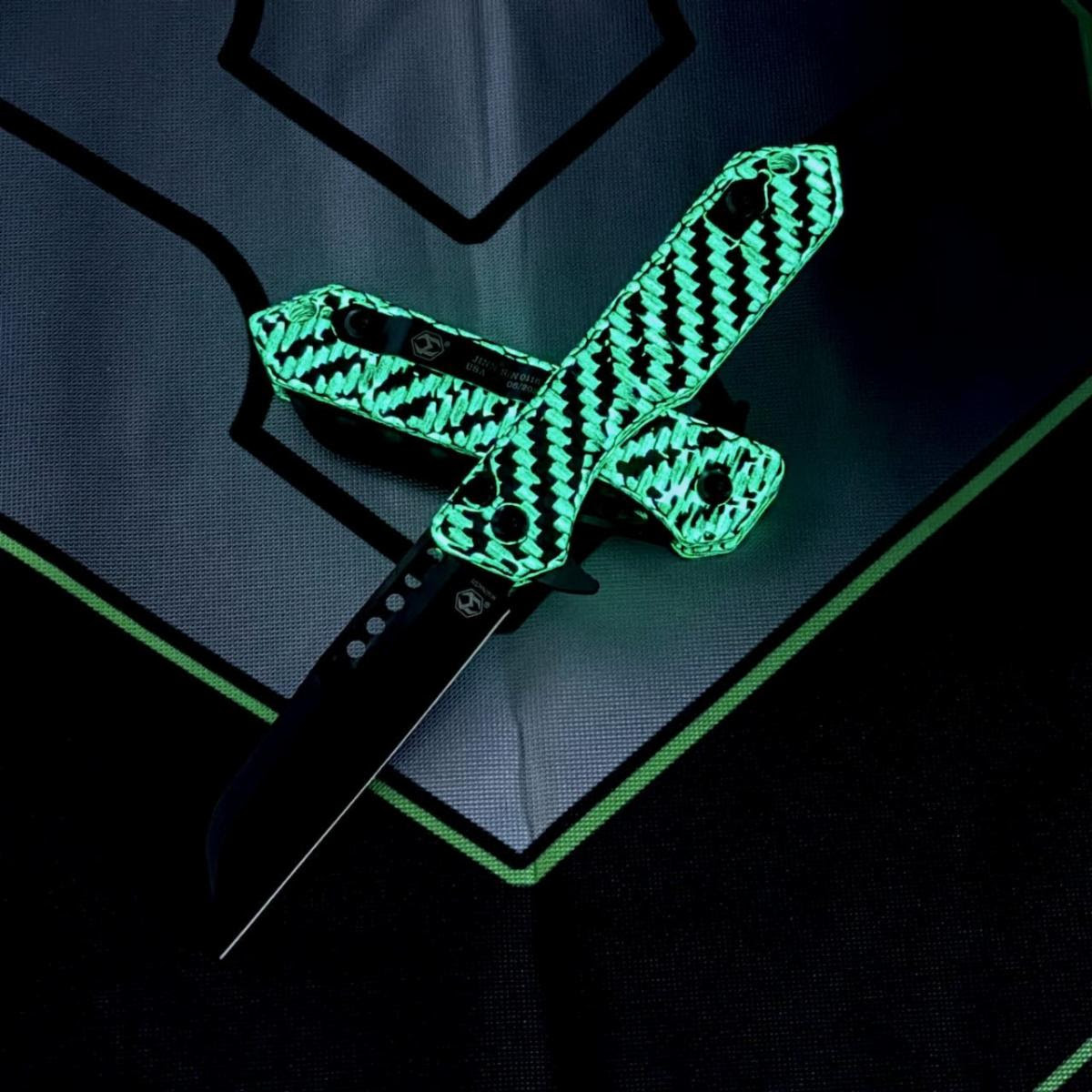 Heretic Knives Jinn Manual H213-6A-GLOCF — 3.0" CPM-MagnaCut DLC black Wharncliffe, glow-in-the-dark carbon fiber handle glowing green, button lock, USA made