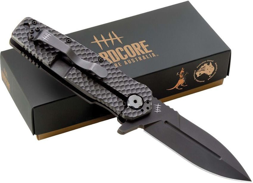 LONG IMAGE DESCRIPTION: Hardcore Hardware Australia MILF-05 shown in the closed position against a white background. The handle features black 3D textured G-10 scales with jimping visible at the front and rear. The 420 stainless frame lock and liner construction is visible on the lock side. The 420 stainless pocket clip is shown in tip-up position on the spine. The glass breaker pommel is visible at the butt end. The oversized T10 Torx adjustable pivot is visible at the blade pivot point.