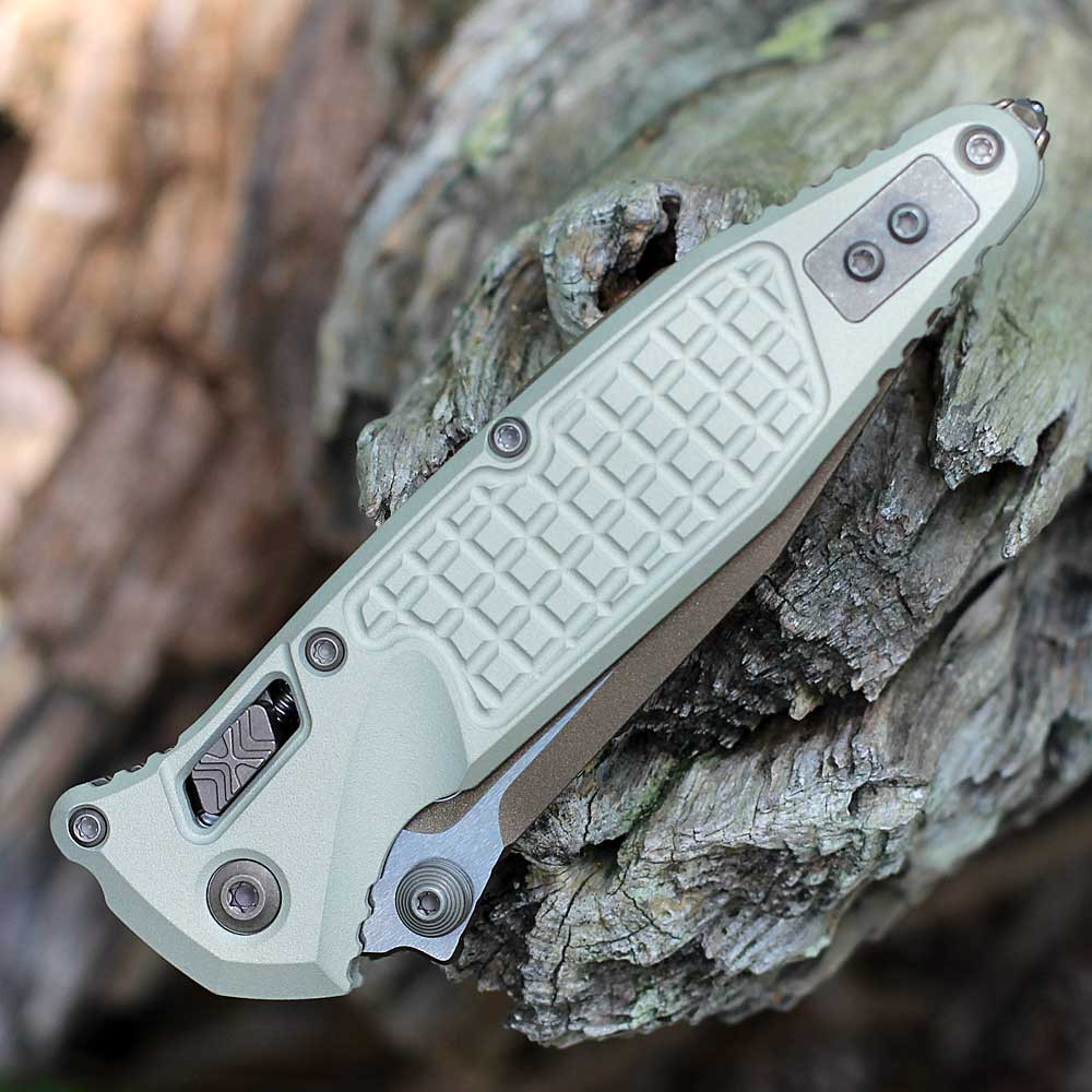 Microtech Socom RAM-LOK 160RL-1FRCG-C19Z23 — front view closed, champagne gold frag anodized aluminum handle, tip-up reversible pocket clip
