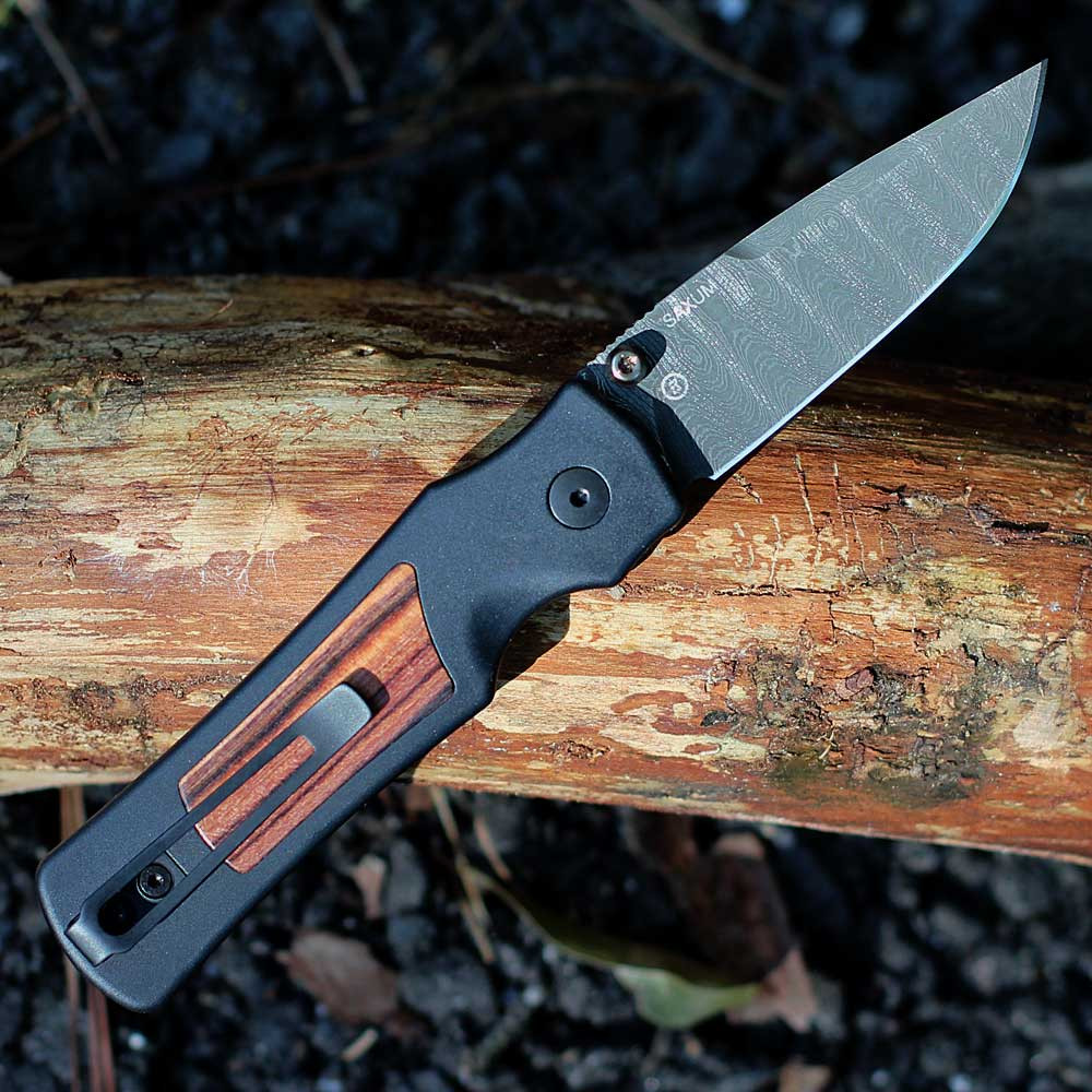 Hogue Saxum 24690-LIM Damascus drop point blade — 2.80 in, 0.125 in thick, 57-59 HRC, bronze anodized titanium thumb studs, pattern varies