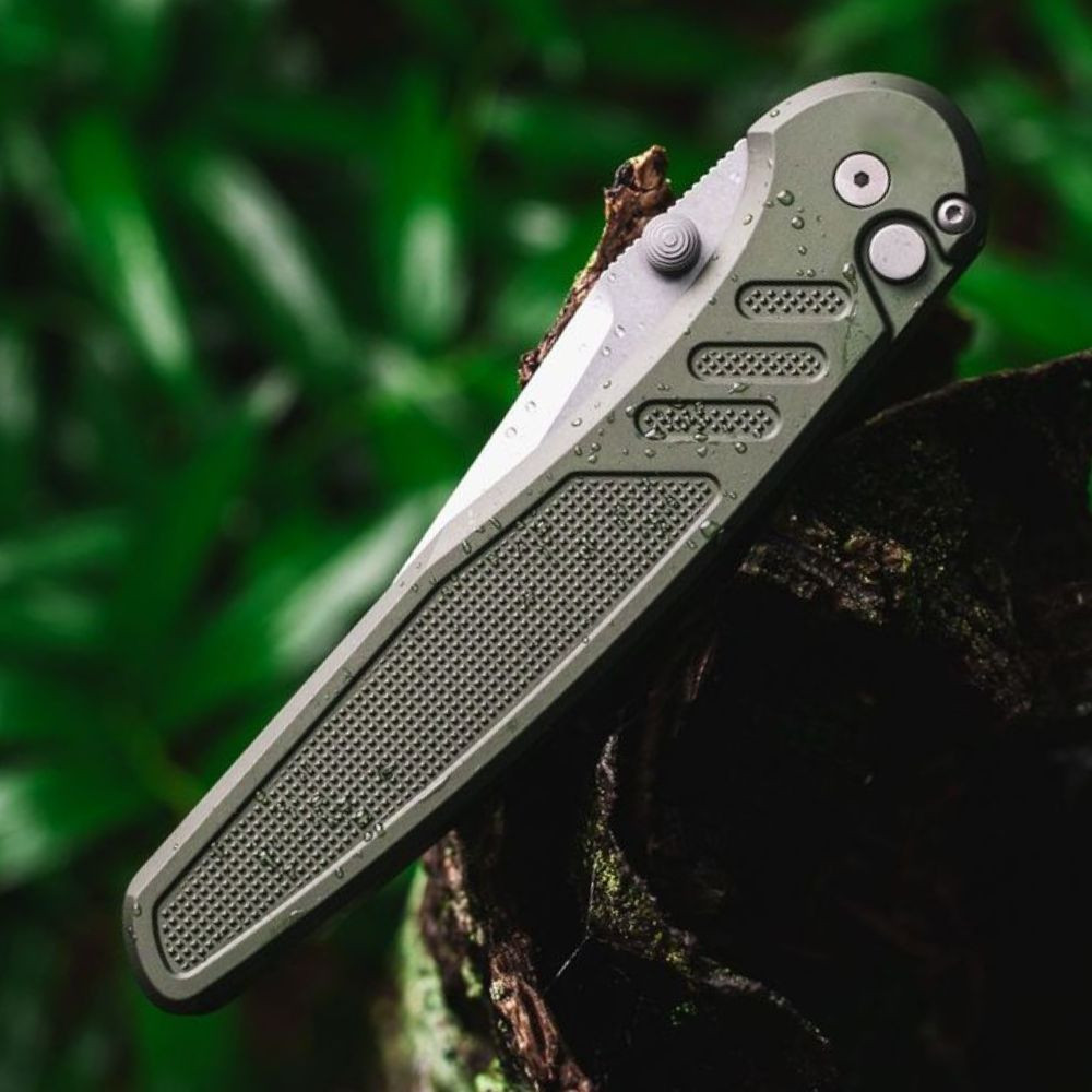Pro-Tech Avalon Peace Neighbor PN1101-GREEN — open, angled view showing dual thumb studs and deep carry clip, outdoor setting