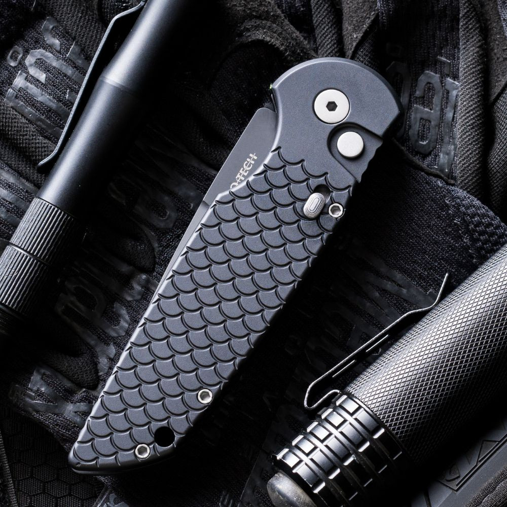 Pro-Tech TR-3 X1 Military Issue TR-3 X1 M — closed, black fish scale aluminum handle, DLC black 3-hole spear , tactical gear background