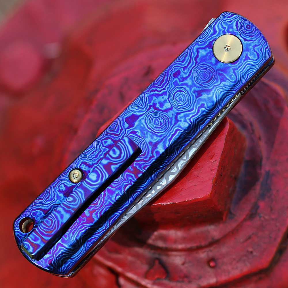 Boker Germany BRLW Fulldress 110675DAM Mokuti handle — iridescent violet blue Ti-Cu-Zr alloy, gold pivot screws, Liner Lock, flipper