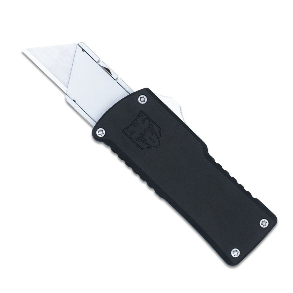 The CobraTec OTF Utility Knife (CTOTFUTBLK) shown with its dual action OTF mechanism, standard replaceable utility blade, black anodized 6061-T6 aluminum handle, and its right-hand carry pocket clip. The spring-loaded blade lock arrow used for blade changes is visible on the carrier. ⚠️ This is an OTF automatic knife — verify legal status in your jurisdiction before purchasing.