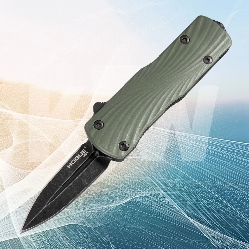 The Hogue Micro Counterstrike (34701) automatic OTF knife shown with its 1.95-inch double edge CPM-MagnaCut blade in a black stonewash finish, ornately milled 6061-T6 anodized aluminum case, OD Green glass fiber reinforced polymer cover, and deep carry reversible pocket clip.