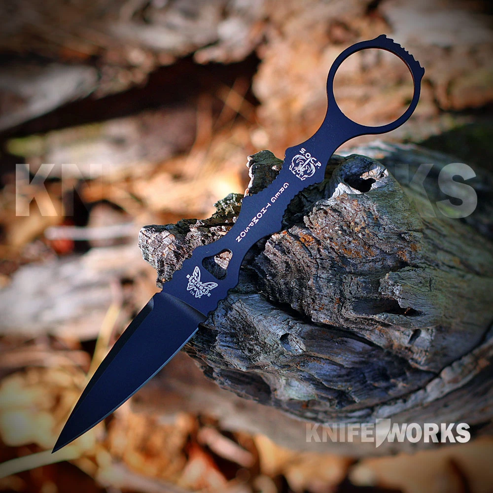 The Benchmade SOCP Single-Edge Dagger shown with its 2.75-inch black Cerakote 440C spear-point blade with a single sharpened edge and full flat grind, black handle, and lightweight black MOLLE-compatible sheath with a J-hook style deep-carry clip.