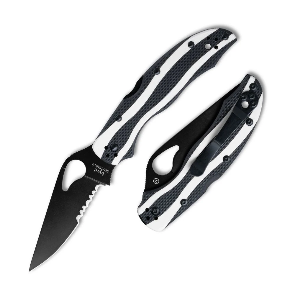 The Byrd Magpie Black Blade is shown open in profile, with a black-coated full-flat ground drop-point blade that is partially serrated near the handle, and a round thumb hole. The handle has black textured G10 scales with flowing white inlays and a black pocket clip.