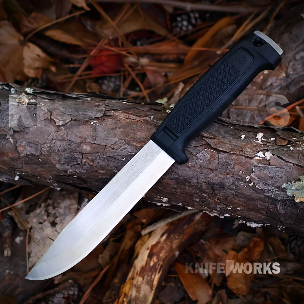 The Morakniv Mörkret Elmax (S) is shown with its full-tang Elmax blade and black textured handle with a finger guard and lanyard hole. Its black Click-On sheath is shown alongside.