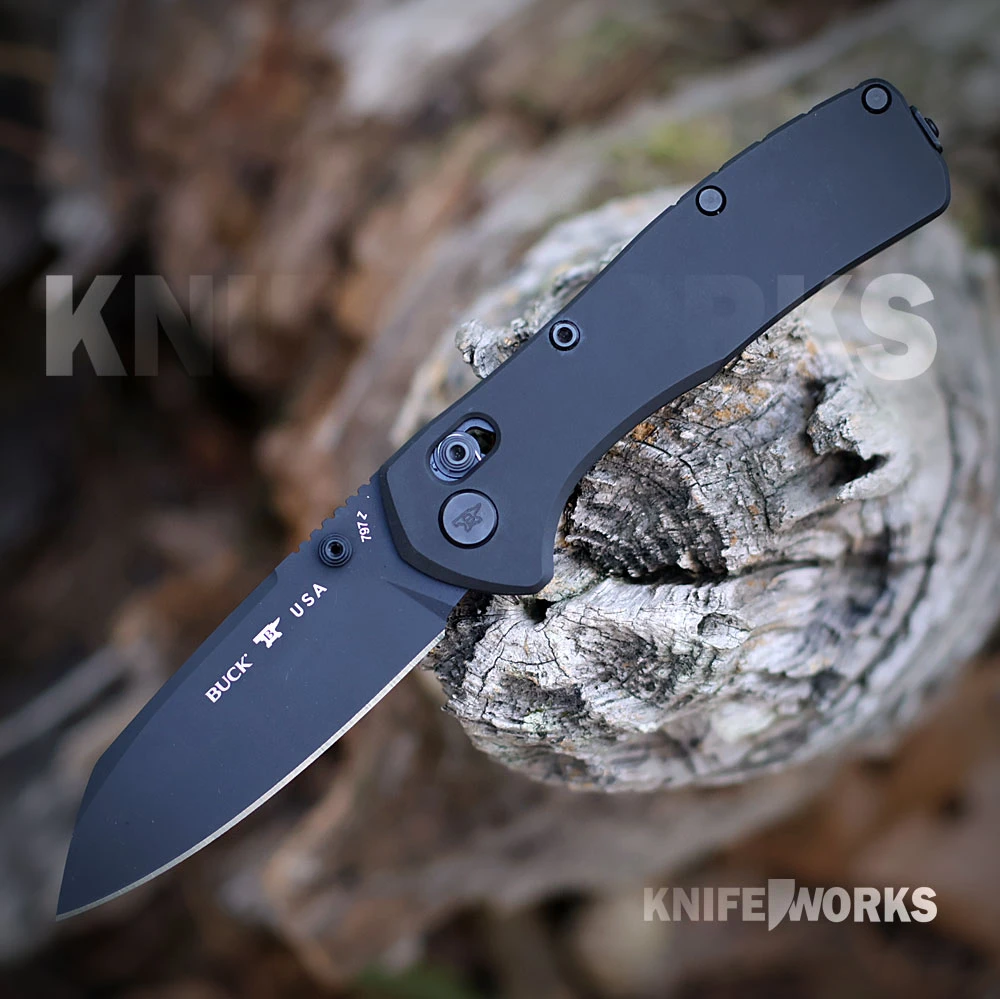 The Buck Range Ops Elite 0797BKS is shown open, featuring a black Cerakote CPM MagnaCut reverse tanto blade, crossbar lock, and black aluminum handle with a deep-carry pocket clip.