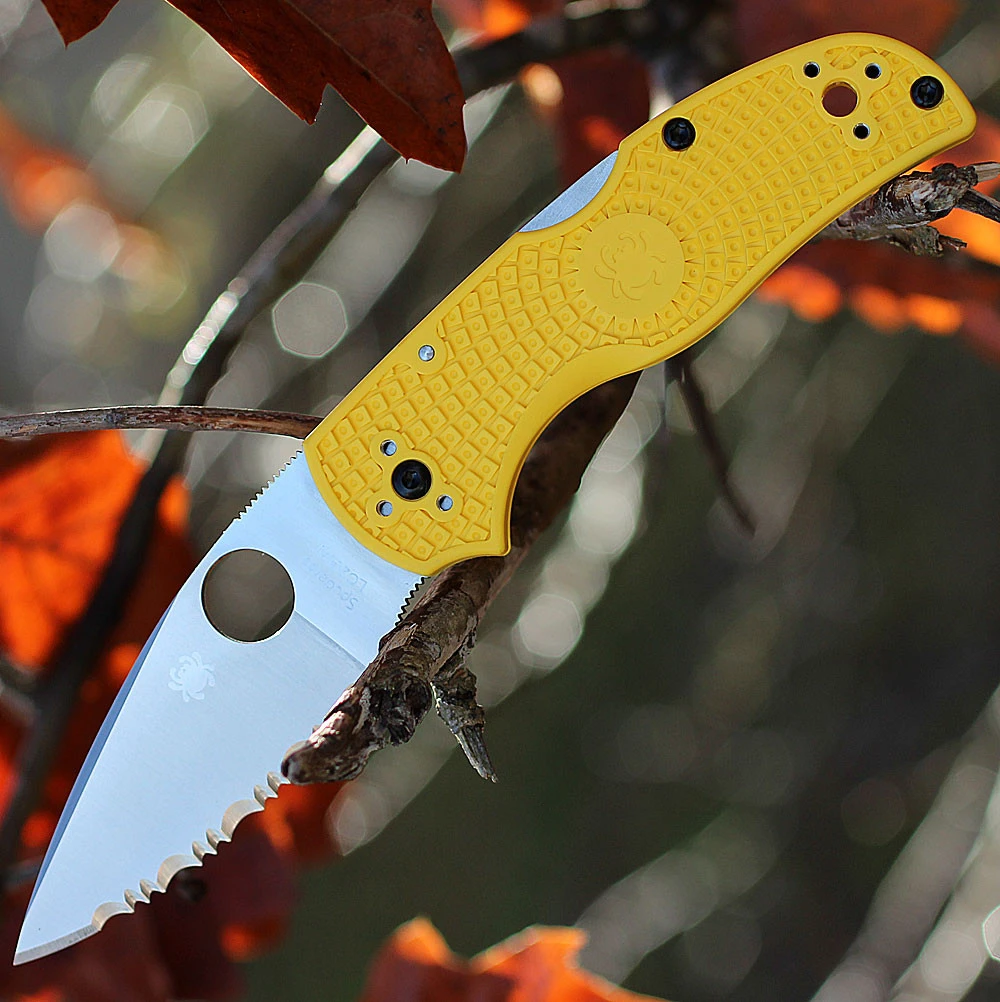 The Spyderco Native 5 Lightweight Salt C41SYL5 is shown open, with its fully serrated CPM MagnaCut blade and Trademark Round Hole extending from a bright yellow textured FRN handle with a pocket clip.