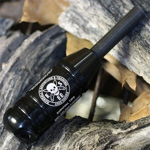 The ESEE Standard Fire Kit (ESEE-FIRE-KIT), a black watertight survival capsule with a 20mm button compass in the cap and survival tips printed on the body.