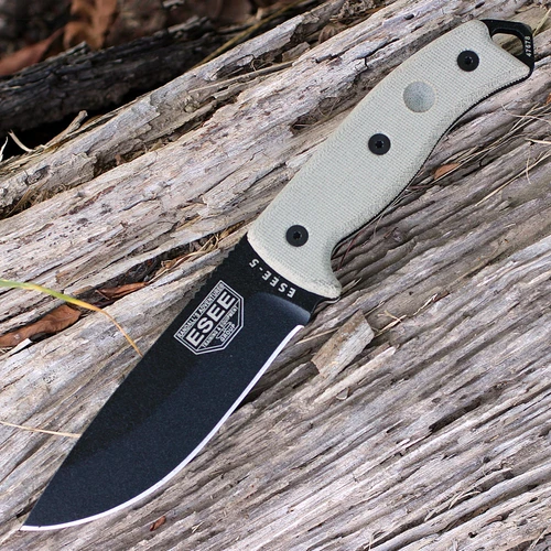 The ESEE-5 (ESEE-5P-E) shown with its 5.25-inch 1095 saber ground drop point blade in a black finish, sharpened glass breaker pommel, fire-making bow drill divot, tan Micarta handle scales, and its black Kydex belt sheath.