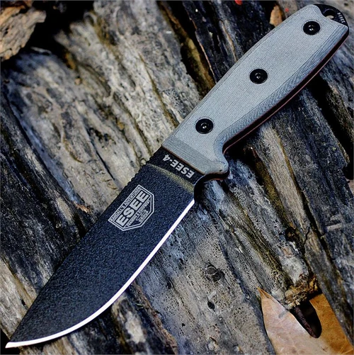 The ESEE-4 (ESEE-4P-B) shown with its 4.50-inch 1095 plain edge drop point blade in a black finish and tall flat grind, gray Micarta handle scales, and its injection-molded black polymer sheath.