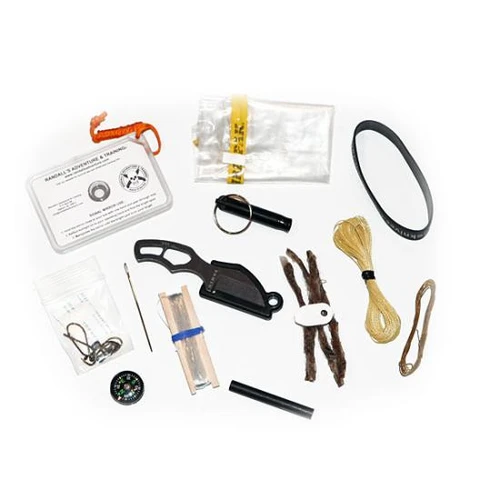 The ESEE Pinch Kit shown with its small embossed survival tin open, revealing the James Gibson-designed Pinch neck knife in 1095 black oxide steel with its magnetic retention sheath, RAT signal mirror, button compass, fishing kit, fire starter, and the rest of the kit's contents.