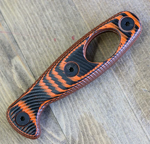 The ESEE Xancudo Optional Handle (XAN1-HANDLE) shown in black and orange G-10, a set of handle scales designed to fit the ESEE Xancudo fixed blade.