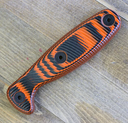 The ESEE Xancudo Optional Handle (XAN2-HANDLE) shown in black and orange G-10, a no-hole set of handle scales designed to fit the ESEE Xancudo fixed blade.