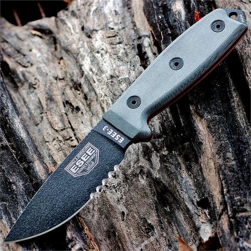 The ESEE-3 Fixed Blade (ESEE-3S-MB-B-CO) shown with its 3.88-inch 1095 carbon steel drop point blade in a black finish with partial serration and flat grind, gray Micarta handle scales, and its injection-molded black sheath with MOLLE back attachment.