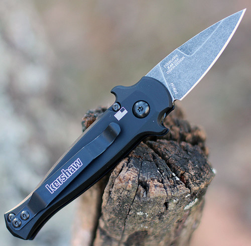 Kershaw Launch 12 CA being deployed via push button showing the integrated finger guards and deep-carry pocket clip.
