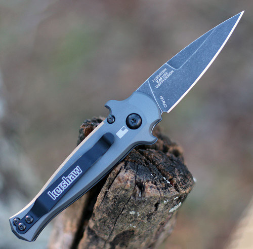 Kershaw Launch 12 being deployed via push button showing the integrated finger guards and reversible pocket clip.