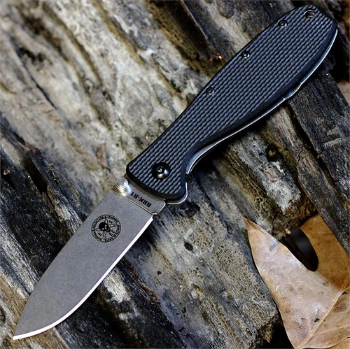 The ESEE Zancudo (BRKR1) shown with its 2.94-inch AUS-8 drop point blade in a stonewash finish and flat grind, black polymer handle with steel frame lock, and reversible pocket clip for tip-up or tip-down carry.