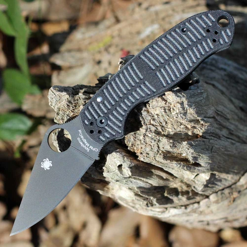 The Spyderco Para 3 Salt C223GMCBKP is shown open . The black DLC-coated clip point blade with a Trademark Round Hole extends from a black G-10 handle with a machined texture and black hardware.