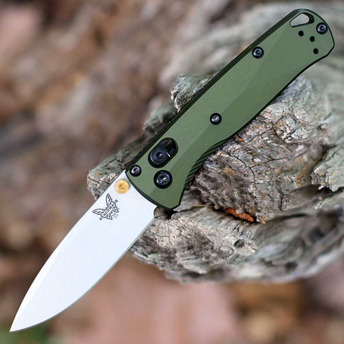 The Benchmade Mini Bugout 533SL-10 is shown open, featuring a 2.82-inch Crushed Silver Cerakote CPM-S90V drop point blade extending from a Woodland Green 6061-T6 aluminum handle with dual thumb studs and AXIS Lock mechanism.