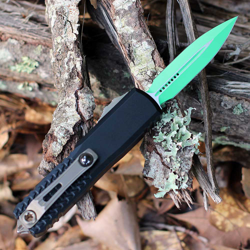 Microtech UTX-85 12321-1JM Jedi Master green Bohler M390MK double edge blade — serrations, fuller, OTF deployed position