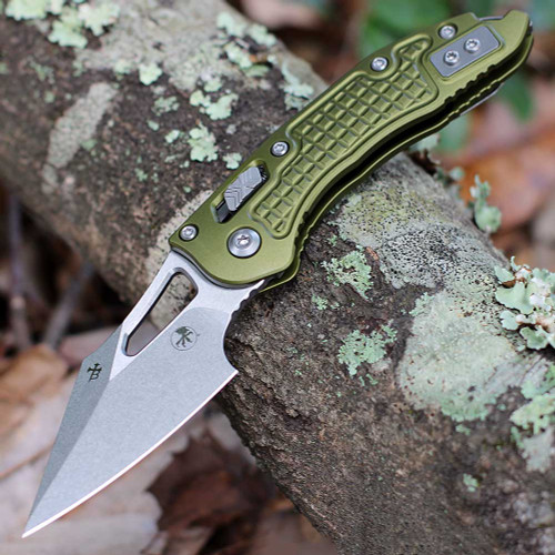 Microtech Mini Stitch RAM-LOK 169MRL-10FROD open — Bohler M390MK stonewash spear point blade, OD green frag pattern 6061-T6 aluminum handle