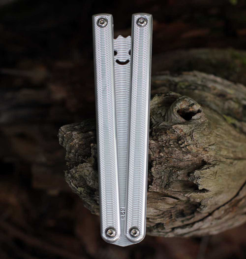 Squid Industries Squiddy-AL Trainer SQUIDDY-AL closed — silver CNC textured 6061-T6 aluminum monoblock channel handles, pivot hardware, smiley face cutout visible