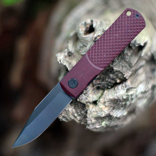 Boker Germany 2026 ADK BRLW 110673 open — CPM MagnaCut PVD drop point blade, red Richlite handle, Liner Lock, ball bearing flipper