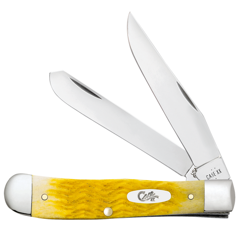 Case Trapper (75310) shown in the closed position against a white background. The handle is yellow Platts jigged cattle bone with a fine, tightly packed jig texture and a nickel silver oval script Case shield inlay at the center. High-polished nickel silver bolsters are visible at both ends. The nail nicks on both the clip point and spey blades are visible at the pivot end. The brass liner frame is partially visible at the handle edges.