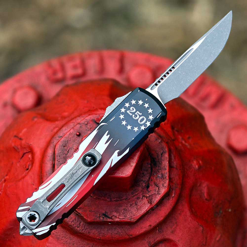 Microtech UTX-85 4th of July 250th Anniversary open, back view showing thumb slide lock and glass breaker on aluminum handle
