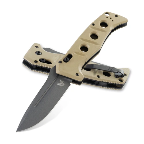A Benchmade Auto Adamas folding knife shown with the blade deployed alongside its tan ballistic nylon MALICE Clip sheath, highlighting the MagnaCut Tungsten Gray Cerakote drop-point blade and Desert Tan G10 handle with integrated spine safety switch.