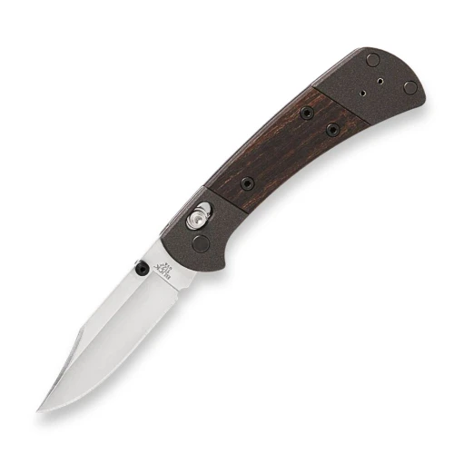 The Buck 112 Crossbar Elite (0112BRS18-B) shown with its 3-inch MagnaCut clip point blade in a satin finish, Cobalt Cerakoted aluminum handle with DymaLux® Macassar ebony inlays, and its black nitride deep carry reversible pocket clip. The ambidextrous crossbar lock and thumb studs are visible along the spine of this compact Buck Ranger heritage folder.