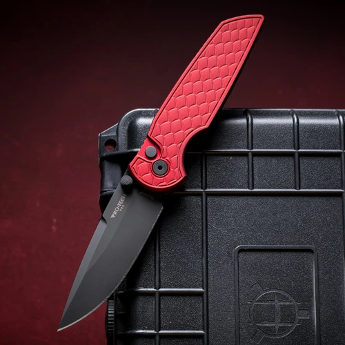 The Pro-Tech Integrity (INT1106-REPTILE RED) shown with its 3.5-inch MagnaCut spear point blade in a DLC black finish, red reptile textured 6061 aluminum handle, black hardware, and its black wide deep carry pocket clip. The button lock release and double thumb studs are visible along the spine of this manual EDC folder.