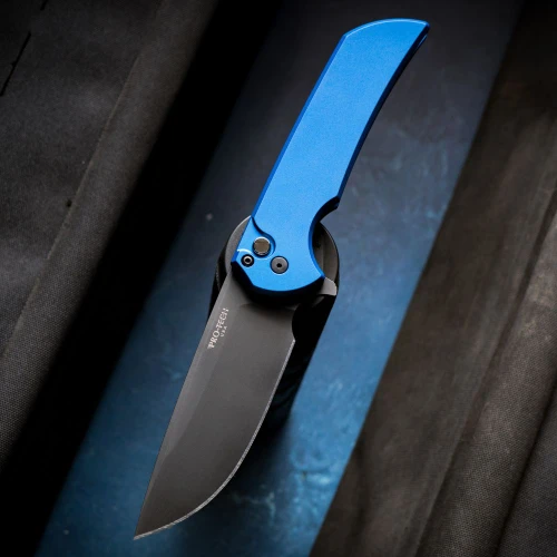 The Pro-Tech Mordax Limited Blue (MX103-LTD BLUE) shown with its 3.62-inch CPM MagnaCut drop point blade in a black DLC finish and flat grind, solid blue aluminum handle with black hardware and a black lip pearl button, and its DLC black deep carry tip-up pocket clip. The flipper tab is visible along the spine of this limited-edition manual folder.