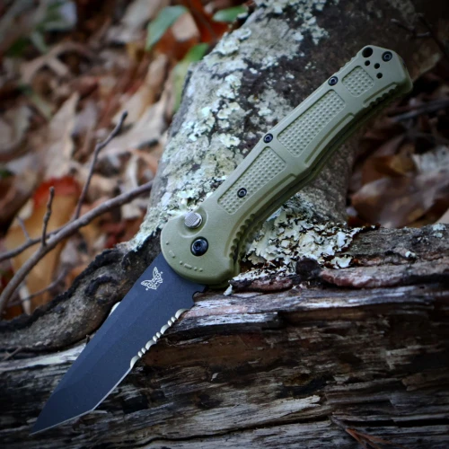 The Benchmade Claymore Auto (9071SBK-03) shown with its 3.60-inch 154CM combo tanto blade in a Cobalt Black finish and flat grind, Ranger Green Grivory handle with deeply molded texture, and its reversible deep-carry tip-up pocket clip. The push button with integrated safety lock is visible on this automatic knife. ⚠️ Verify legal status in your jurisdiction before purchasing.