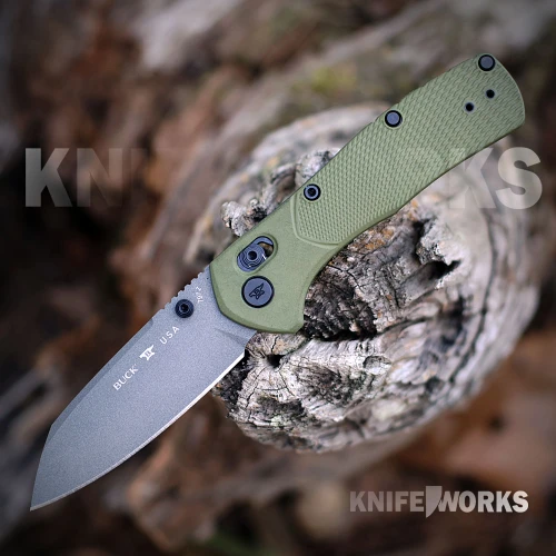 The Buck Range Ops Pro 0797GRS1 is shown open, featuring a gray Cerakote 154CM reverse tanto blade, crossbar lock, and OD green GFN handle with a deep-carry pocket clip.