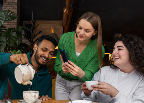 Friends enjoying tea together at a table
