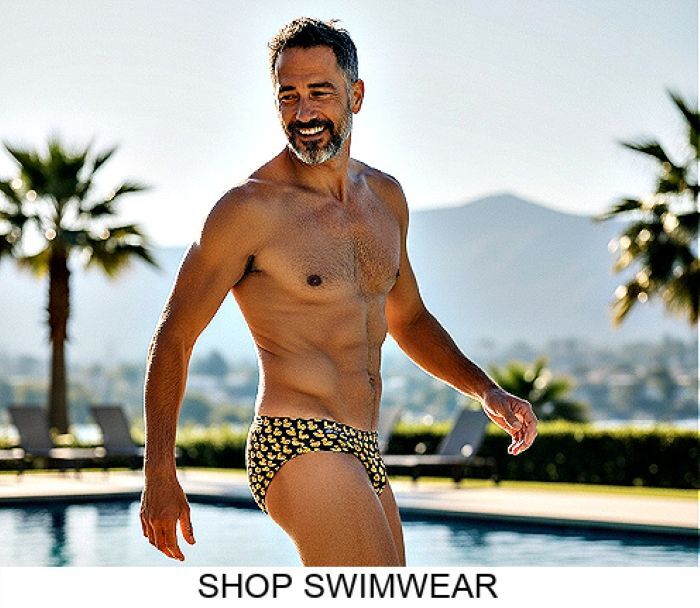 Shop the Jack Adams Fall-Winter 2025 Swim Line.  Model wearing a pair of Jack Adams Just Ducky Low-Rise 1" Swimsuit in black, shirtless and twisted toward you view.