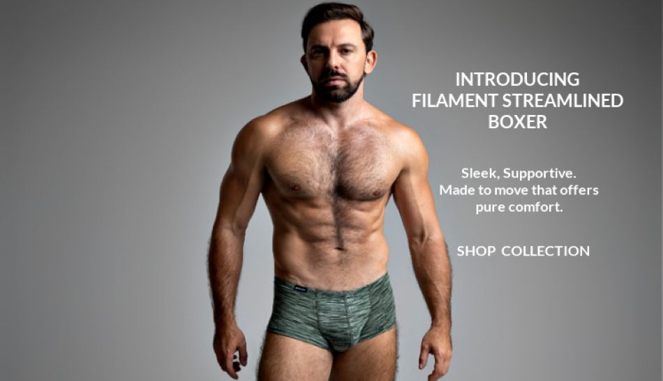 Introducing the Filament Streamlined Boxer. Shop the Collection. Model wearing a pair of Jack Adams Filament Streamlined Boxer in  natures green, front view.