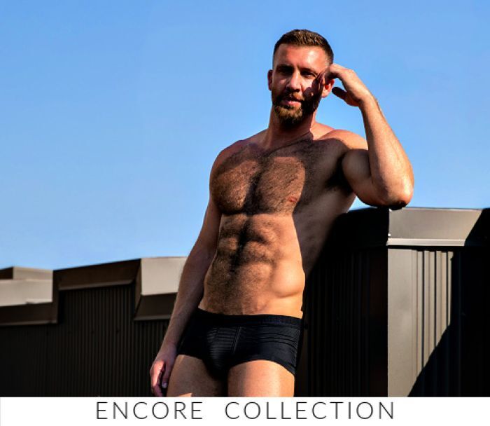 Shop the Jack Adams Encore Collection. Image: Model wearing a pair of Jack Adams Encore Shorty Trunk in black.