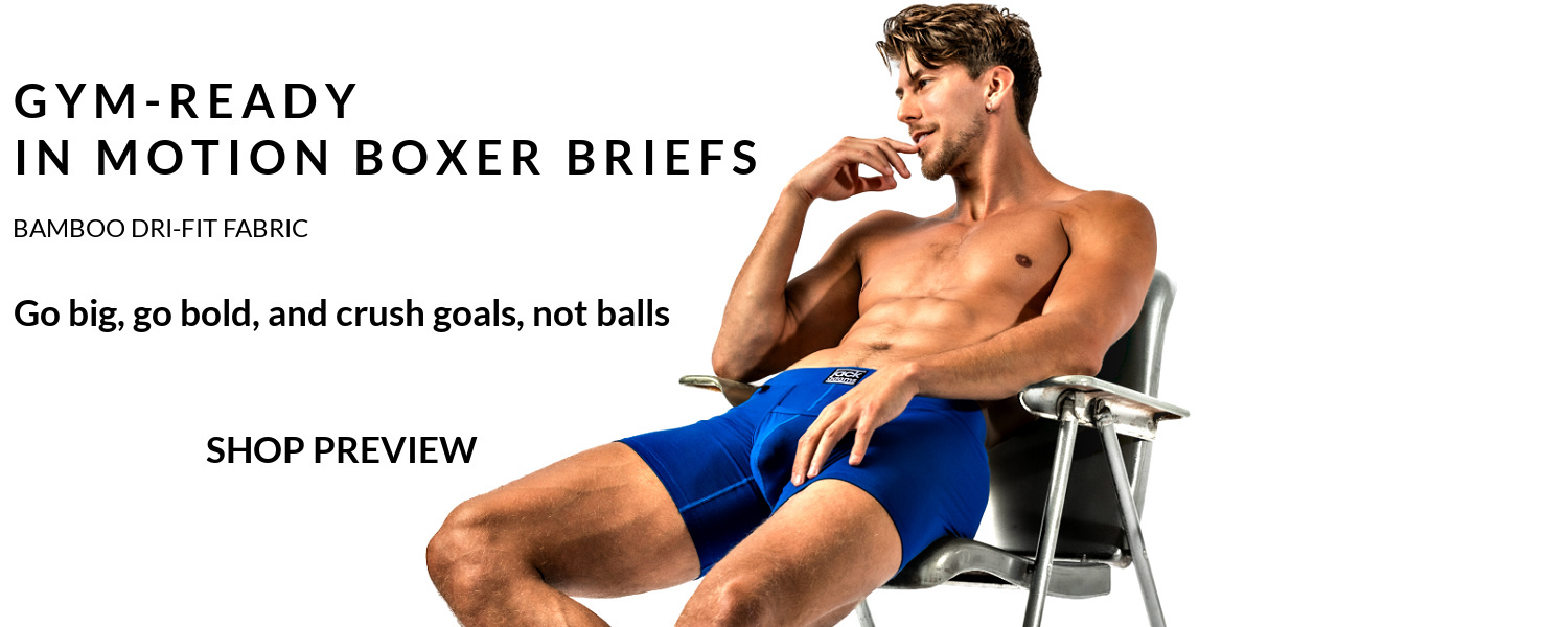 Gym-ready In Motion Boxer Briefs. Shop Preview.  Image: Modal is sitting on a lawn chair wearing a pair of royal In Motion Boxer Briefs.