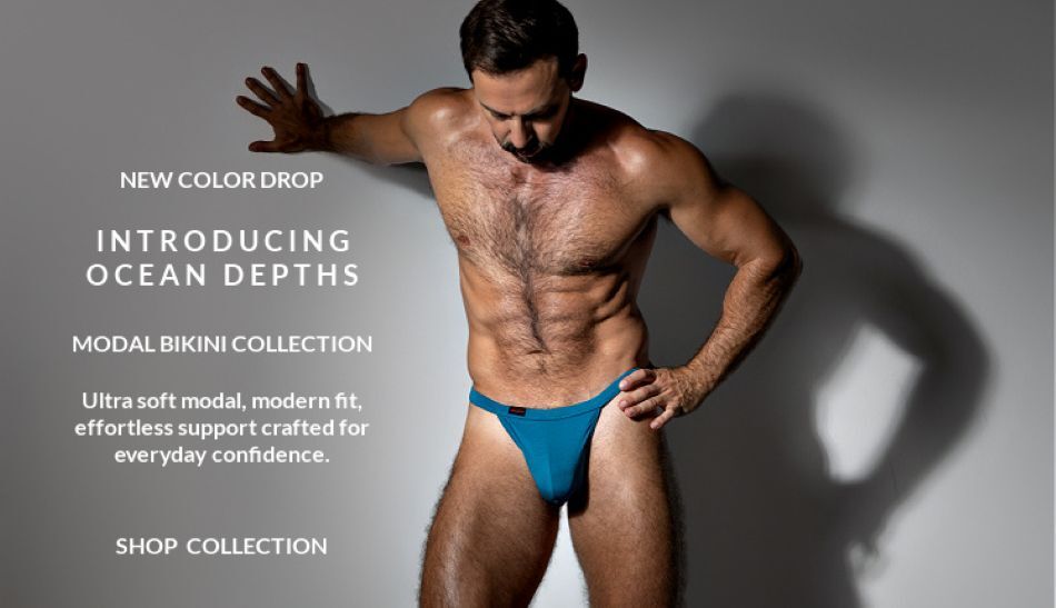 New color drop. introducing Oceans Depth. Modal Bikini Collection. Model wearing a pair of Jack Adams Modal Bikini Thong in oceans depth, front view.