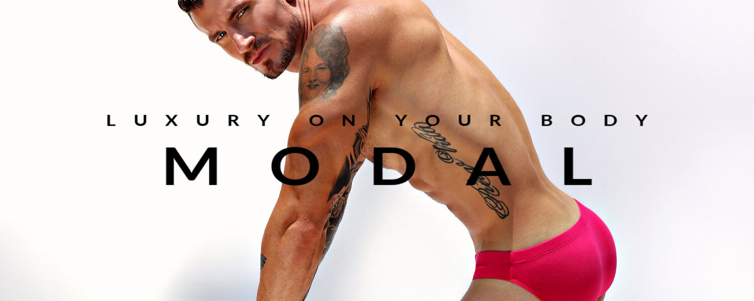 Luxury on your body. MODAL.  Image is of a man only wearing a pair of  innuendo pink Bikini Briefs.