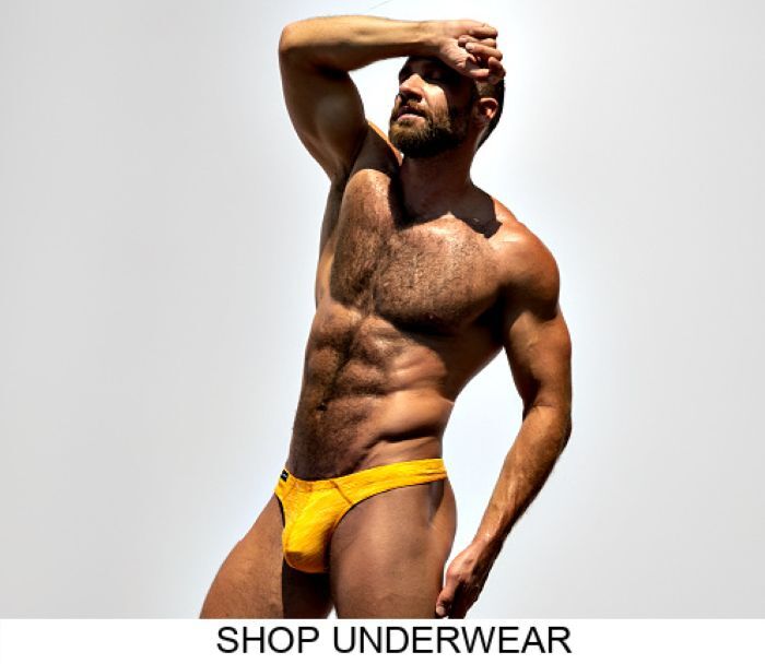 Shop the Jack Adams Underwear Fall-Winter 2025 line.  Model wearing a pair of Jack Adams Filament Bikini Briefs in orange cream, profile view.